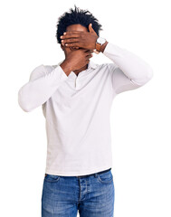 Sticker - Handsome african american man with afro hair wearing casual clothes and glasses covering eyes and mouth with hands, surprised and shocked. hiding emotion