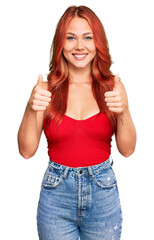 Poster - Young redhead woman wearing casual clothes success sign doing positive gesture with hand, thumbs up smiling and happy. cheerful expression and winner gesture.