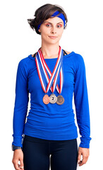 Wall Mural - Beautiful young woman with short hair wearing winner medals thinking attitude and sober expression looking self confident