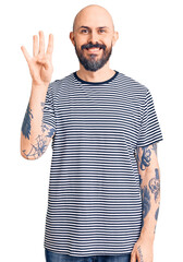 Sticker - Young handsome man wearing casual clothes showing and pointing up with fingers number four while smiling confident and happy.