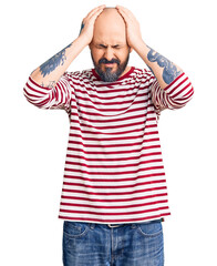 Wall Mural - Young handsome man wearing casual clothes suffering from headache desperate and stressed because pain and migraine. hands on head.