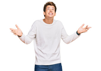 Wall Mural - Handsome caucasian man wearing casual white sweater crazy and mad shouting and yelling with aggressive expression and arms raised. frustration concept.