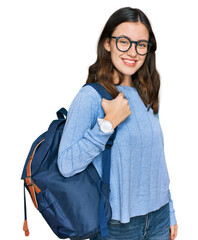 Young beautiful girl wearing student backpack looking positive and happy standing and smiling with a confident smile showing teeth