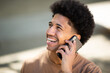 © mimagephotos - African American man talks on his mobile phone