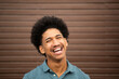 © mimagephotos - happy young man with afro