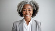 © Marko - mature older woman with curly hairstyle, gray hair, wearing simple light gray suit and white shirt, smiling relaxed or proud