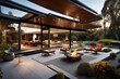 A mid-century modern residence with clean lines, a flat roof, and expansive glass walls opening up to a backyard deck with outdoor seating and a fire pit.