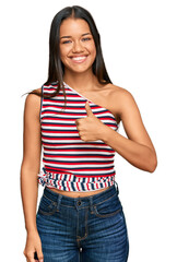 Sticker - Beautiful hispanic woman wearing casual clothes doing happy thumbs up gesture with hand. approving expression looking at the camera showing success.