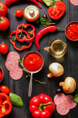 Wall Mural - Different ingredients for preparing pizza on dark wooden background