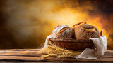 Fototapeta  - Fresh baked homemade of loaf bread on a napkin with wheat  on rustic background.