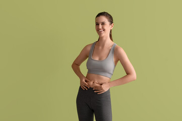 Poster - Sporty young woman on green background