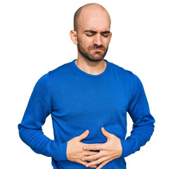 Wall Mural - Young hispanic man wearing casual clothes with hand on stomach because indigestion, painful illness feeling unwell. ache concept.