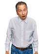 © Krakenimages.com - Middle age indian man wearing casual white shirt scared and amazed with open mouth for surprise, disbelief face