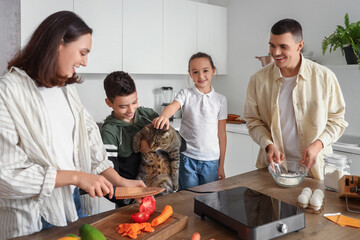 Canvas Print - Happy family with cat cooking in kitchen