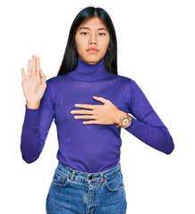 Poster - Beautiful young asian woman wearing casual clothes swearing with hand on chest and open palm, making a loyalty promise oath