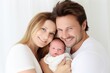© Alina - Pretty woman and man holding newborn baby on white background