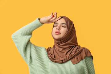 Sticker - Pretty young Muslim woman in hijab on yellow background