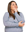 © Krakenimages.com - Beautiful brunette plus size woman wearing casual clothes with hand on chin thinking about question, pensive expression. smiling with thoughtful face. doubt concept.