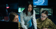 © ihorvsn - Two young Caucasian girls in uniforms of soldiers studying in military controlling office. Asian female teacher teaching women of army to be dispatchers in monitoring room.
