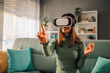© Zamrznuti tonovi - Smile happy woman getting experience while using VR headset glasses