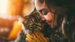 Close-up of a woman affectionately nuzzling a cat
