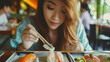 beautiful smiling young woman eating sushi with Chinese chopsticks, rolls, seafood, restaurant, cafe, salmon, rice, nori, eel, caviar, shrimp, bar, portrait, face, girl, lunch, food, dinner