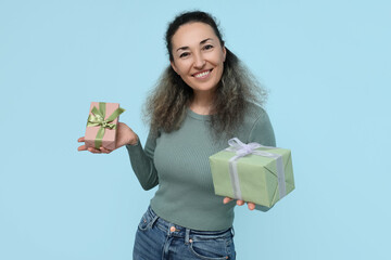 Mature woman with gift boxes on blue background. International Women's Day