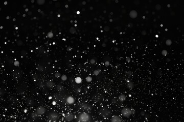 Black and white abstract texture background. Silver glitter and blurred bokeh lights on dark backdrop. Star dust. Background for Christmas, birthday, holiday or event greeting card, banner, print