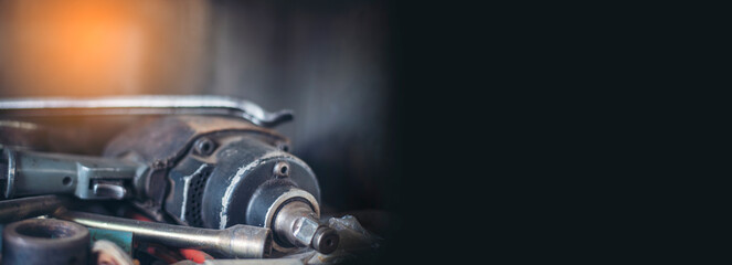 Banner Mechanic tools engineering equipment car auto repair shop with copy space. Blurred background mechanical service. Banner Heavy screw grungy rusted dirty object black background with copy space