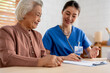 © Kawee - Asian young caregiver nurse examine senior woman patient at home.
