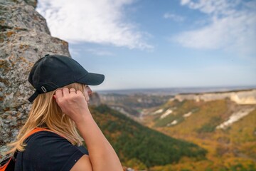Wall Mural - woman backpack on mountain peak looking in beautiful mountain valley in autumn. Landscape with sporty young woman, blu sky in fall. Hiking. Nature