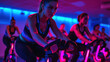© Irina - People biking in Spinning class at modern gym, exercising on stationary bike. A sporty lifestyle