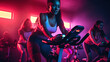 People biking in Spinning class at modern gym, exercising on stationary bike. A sporty lifestyle