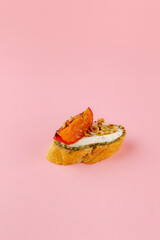 Wall Mural - bruschetta on a fresh baguette on a pink background