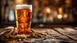 Golden pint of frothy beer with barley ears on a rustic wooden table in a warmly lit tavern