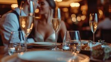 Elegant Business Couple Sitting In Luxury Restaurant With Glass Of Shampagne