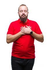 Sticker - Young caucasian hipster man wearing red shirt over isolated background smiling with hands on chest with closed eyes and grateful gesture on face. Health concept.