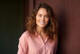Fototapeta  - Portrait of a beautiful young woman with curly hair smiling at the camera