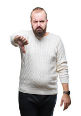 Canvas Print - Young caucasian hipster man wearing winter sweater over isolated background looking unhappy and angry showing rejection and negative with thumbs down gesture. Bad expression.