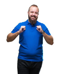 Canvas Print - Young caucasian hipster man wearing blue shirt over isolated background looking confident with smile on face, pointing oneself with fingers proud and happy.