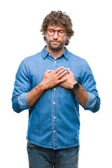 Poster - Handsome hispanic model man wearing glasses over isolated background smiling with hands on chest with closed eyes and grateful gesture on face. Health concept.