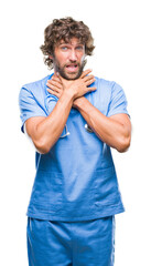 Wall Mural - Handsome hispanic surgeon doctor man over isolated background shouting and suffocate because painful strangle. Health problem. Asphyxiate and suicide concept.