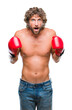 © Krakenimages.com - Handsome hispanic boxer man wearing boxing gloves over isolated background scared in shock with a surprise face, afraid and excited with fear expression
