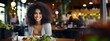 © tetxu - African American woman eating healthy food in a restaurant