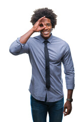 Sticker - Afro american business man over isolated background doing ok gesture with hand smiling, eye looking through fingers with happy face.