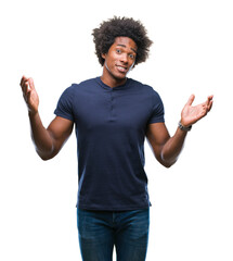 Wall Mural - afro american man over isolated background clueless and confused expression with arms and hands rais