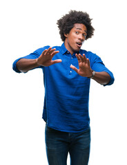 Sticker - Afro american man over isolated background afraid and terrified with fear expression stop gesture with hands, shouting in shock. Panic concept.