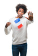 © Krakenimages.com - Afro american man flag of France over isolated background with open hand doing stop sign with serious and confident expression, defense gesture