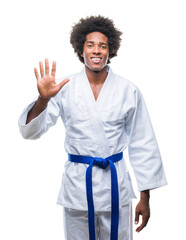 Canvas Print - Afro american man wearing karate kimono over isolated background showing and pointing up with fingers number five while smiling confident and happy.