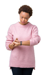 Wall Mural - Beautiful young african american woman over isolated background Checking the time on wrist watch, relaxed and confident